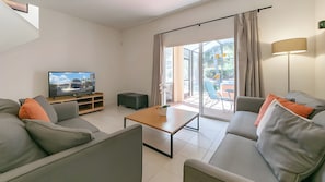 The living area has a 50' smart TV with an Xbox One console, and open view to the private lanai with your own hot tub