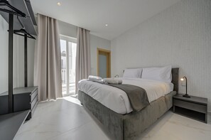 The elegant king bed is the perfect place to rest your head after a day of Malta adventures