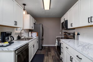 This newly remodeled kitchen features sparkling stainless steel appliances. 