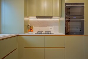 Fully equipped kitchen with cooking utensils, cooking basics, fridge, freezer, oven, stove, microwave, Nespresso coffee machine, dish washer and air ventilation.