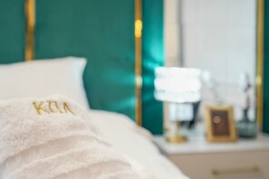 Bedroom with king size bed, cotton linens, towels, mood lights and smart TV.