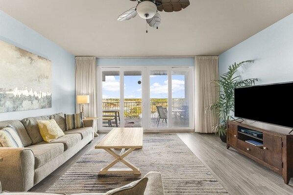 Lake Front Living Area with Flat Screen TV and Privately Furnished Balcony Access