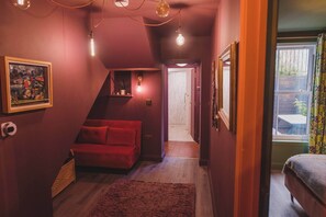 A warmly lit hallway with rich wood details, cozy seating, and a welcoming ambiance.