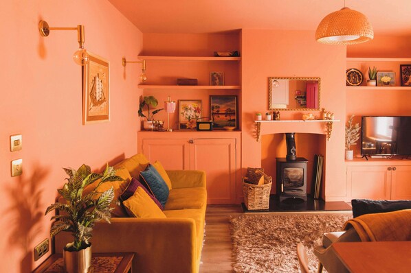 A warm-toned living area with rich terracotta walls, stylish furniture, and inviting textures.