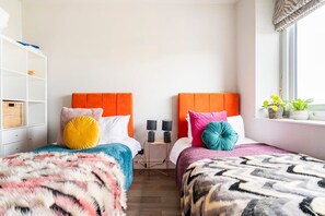 Second bedroom has twin single beds with velvet headboards