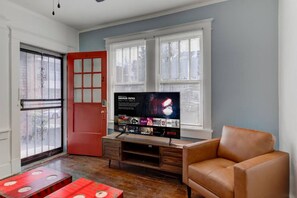 Unwind in a cozy space with Netflix and a relaxing vibe—perfect for a chill evening after a day of exploring Cooper-Young!