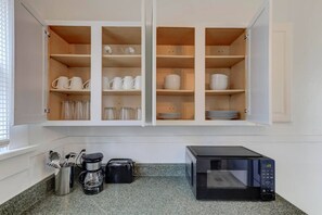 Enjoy your mornings with a perfect coffee station and functional kitchen space.