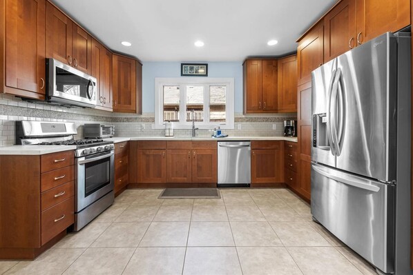 Fully-equipped kitchen with stainless steel appliances and gas range