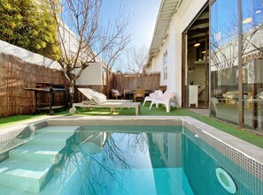 garden and pool area with BBQ