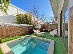 garden and pool area with BBQ