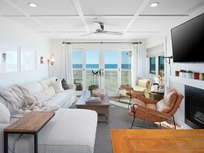 Bright and minimalist, this welcoming space is thoughtfully furnished with contemporary pieces in soft fabrics and warm hues, offering comfortable seating, a Smart TV, and expansive windows overlooking the Pacific Ocean.