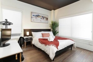 Bedroom with comfortable bed and work areaCozy up in this spacious bedroom with a king-sized bed, work station, and natural light pouring through large windows.