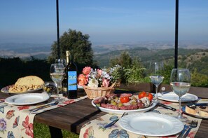 The external table for your dinner overlooking the Chiana Valley with Trasimeno 