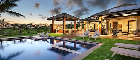 Immerse yourself in luxury at Hale Pakika at Kukui'ula, outdoor living space, ama this pool and spa combo, featuring plentiful seating for sun-soaked gatherings or relaxing days..