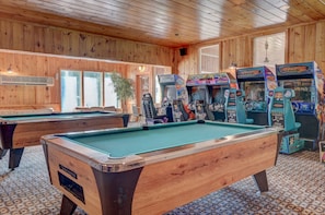 A BIG game room with pool tables and a lot of arcade games!