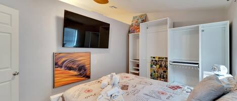 Bedroom #1: Queen-sized bed with smart tv and storage for clothing