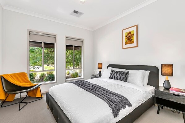 The light and airy primary bedroom features a queen-size bed as well as a pristine ensuite for privacy and ease. 
