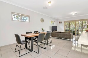Share meals in the open-plan dining area which includes a six-seater table. 

