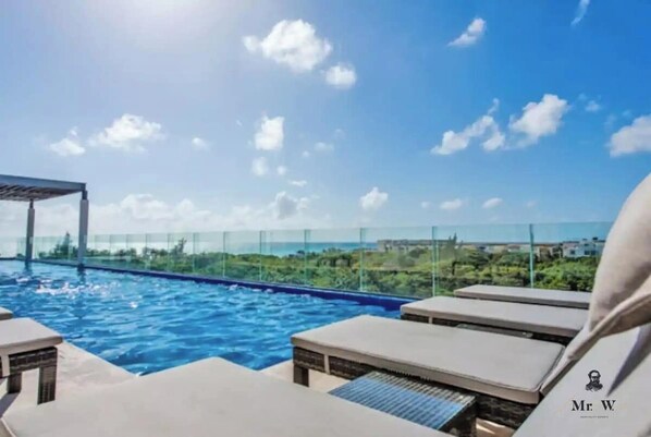 Relax and soak up the sun by the rooftop pool.