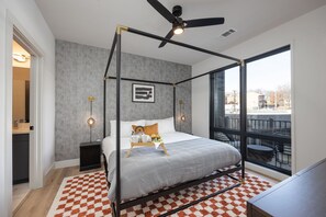 Primary Bedroom with king bed, floor-to-ceiling windows, smart TV, and an en-suite bathroom.