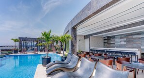 Grab a poolside table and dine al fresco