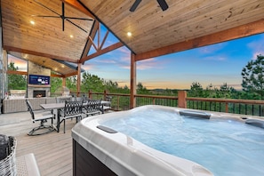 An entertainers paradise with hot tub, fireplace, outdoor dining and Smart TV.