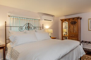 Sleep beautifully in the luxurious king-sized bed with woodland views.