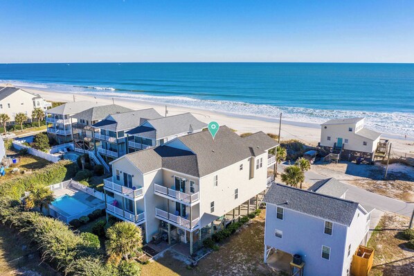 Perched just steps from the shore, this stunning beachside retreat offers sweeping ocean views and coastal charm from above.