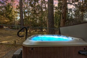 Unwind in your private hot tub surrounded by towering pines — the perfect way to relax after a day of mountain adventures.