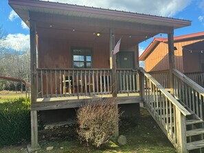 Each Cabin offers an inviting front porch with seating to enjoy the view