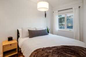 Primary bedroom featuring a comfortable queen bed and stunning mountain views.