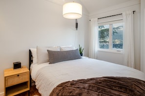 Primary bedroom featuring a comfortable queen bed and stunning mountain views.