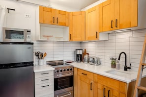 Fully equipped kitchen with sleek stainless steel appliances, perfect for cooking and entertaining.