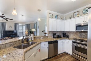 View of the kitchen area fully equipped with stainless steel appliances.