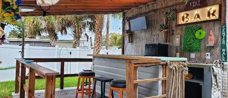 Enjoy watching the game in your own private Tiki Hut bar. 