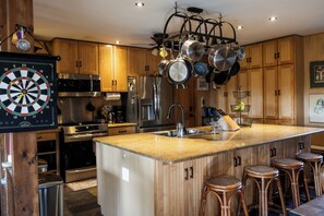 A large chef's kitchen filled with all the essentials + more for all cooking, grilling, & baking. We have the best kitchen around for group meals!
