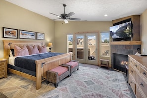master bedroom with king bed, gas fireplace, flat screen and attached bath