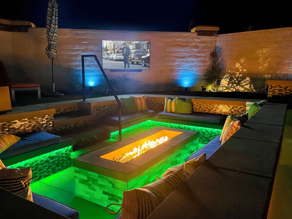Relax with friends and family around the sunken fire pit and watch a movie