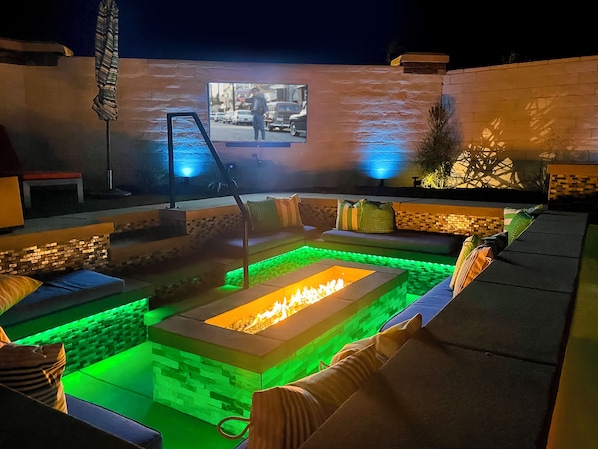 Relax with friends and family around the sunken fire pit and watch a movie