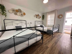 Lovely updated hotel style room with 2 Queen Beds, Mini fridge, smart TV, Kitchenette and private bathroom.