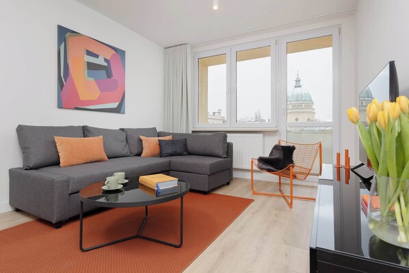 Relax in the stylish living room with a comfortable sofa and modern decor.