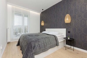 The cosy bedroom features a luxurious double bed and ample storage.