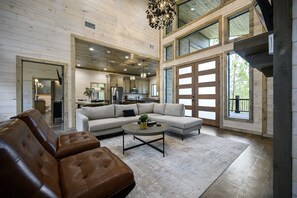 Explore the inviting ambiance of this cabin's living room, where the beauty of nature blends seamlessly with cozy interior design elements 🌲
