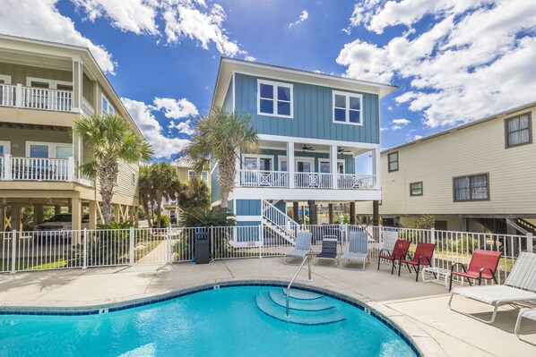 This beautiful lagoon front home is as close to the community pool as it can be.