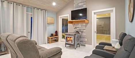 Stay cozy with in-floor heat and custom, decorative wood burning stove.