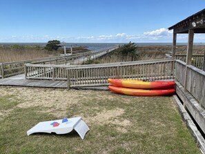 Amenities include two kayaks and cornhole in the sound front yard!