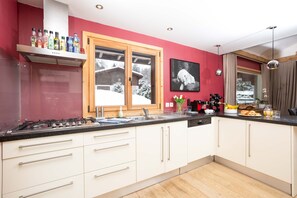 Modern kitchen with mountain views as you do the washing up!