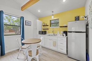 Seating for three and kitchenette.