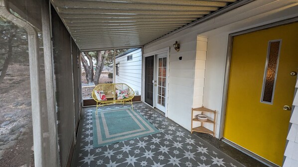 Enjoy a quiet morning on the charming retro screened porch