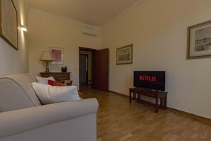 Living room with sofa, air conditioning and smart TV